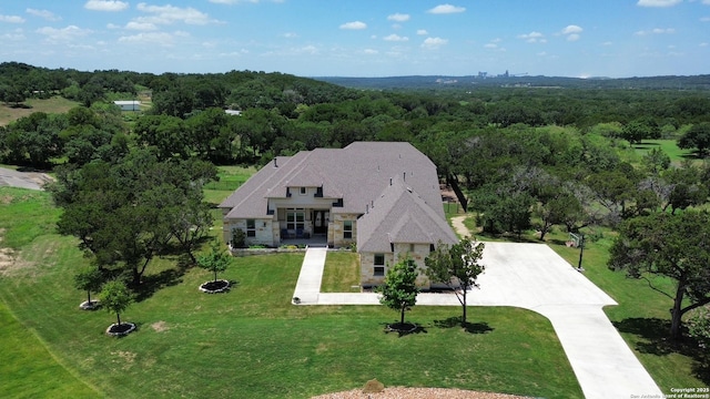 birds eye view of property featuring a view of trees