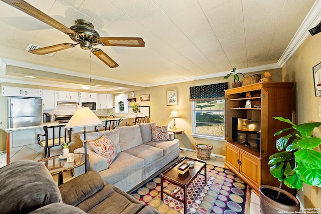 living room featuring light tile patterned floors, baseboards, ornamental molding, and a ceiling fan