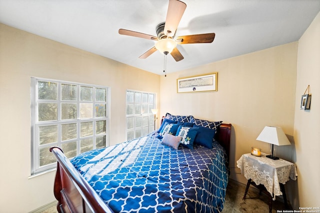 bedroom featuring multiple windows and a ceiling fan