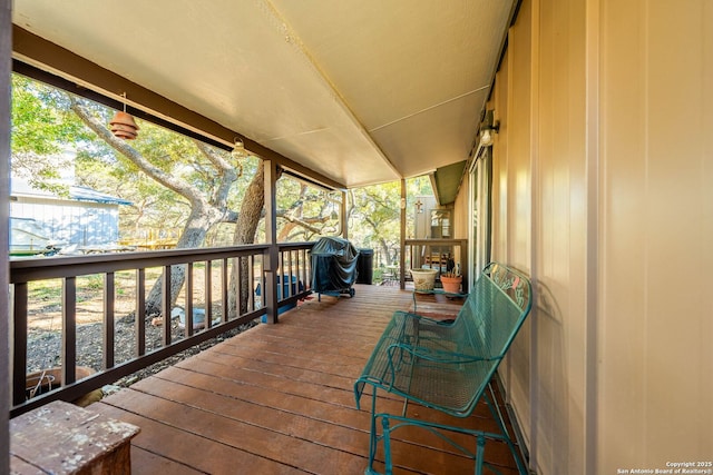 wooden deck with a grill