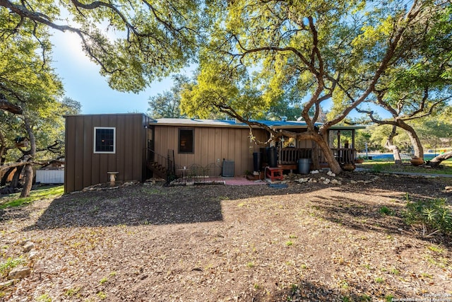 rear view of house with an outbuilding and board and batten siding