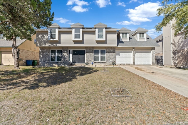 view of front of house with an attached garage, driveway, brick siding, and a front yard