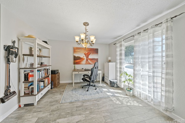 office featuring a chandelier, a textured ceiling, and baseboards