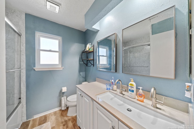 full bath with visible vents, toilet, a textured ceiling, vanity, and wood finished floors