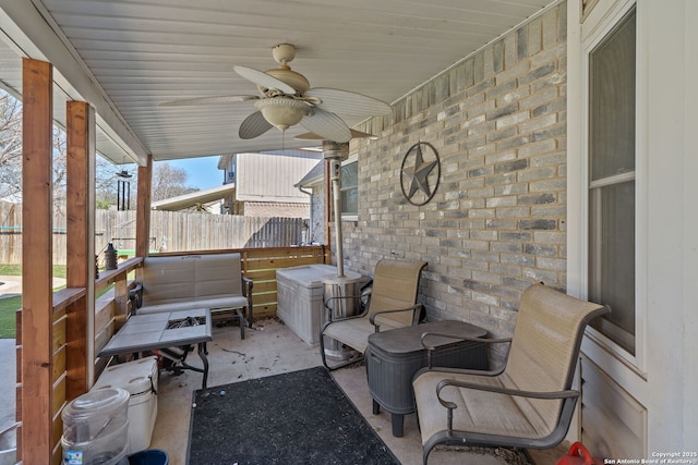 view of patio featuring fence and a ceiling fan