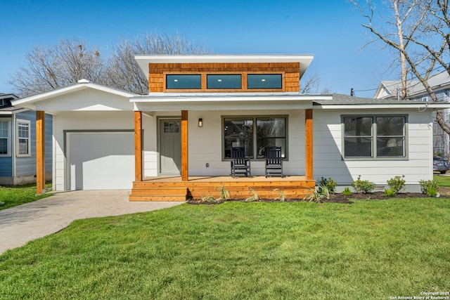 view of front of house featuring an attached garage, concrete driveway, a porch, and a front yard