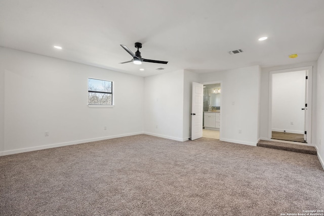 unfurnished bedroom with connected bathroom, recessed lighting, light carpet, visible vents, and baseboards