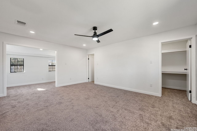 carpeted spare room with a ceiling fan, recessed lighting, visible vents, and baseboards