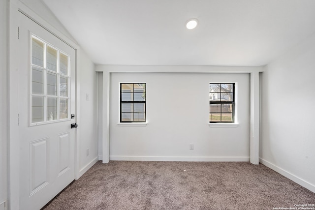 carpeted empty room featuring baseboards