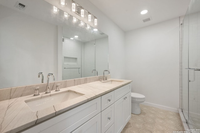 bathroom with baseboards, visible vents, and a sink