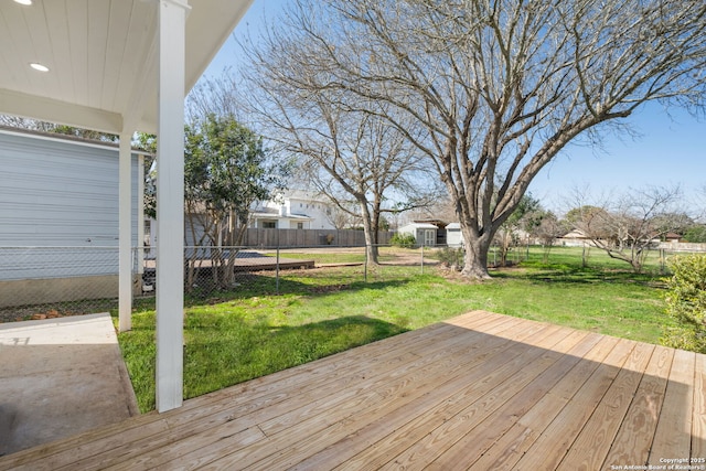 wooden deck with a yard and a fenced backyard