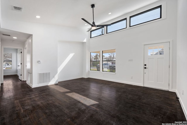 foyer featuring ceiling fan, dark wood finished floors, visible vents, and baseboards