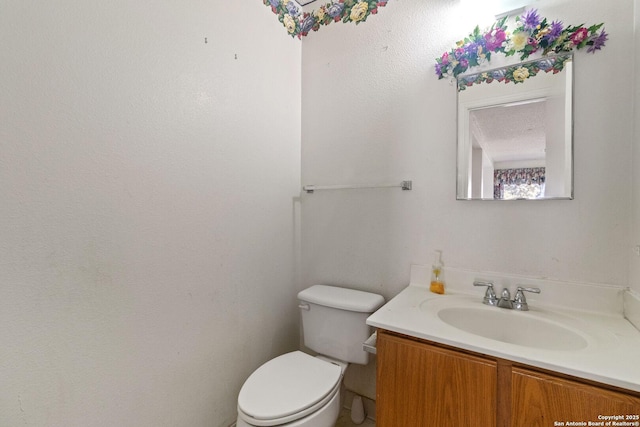 bathroom with toilet and vanity