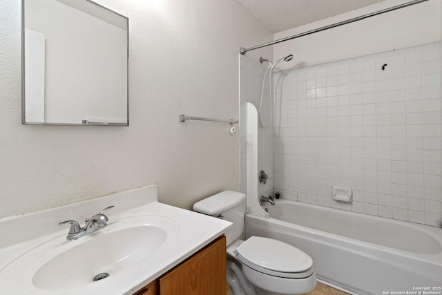 bathroom featuring toilet, vanity, a textured ceiling, and bathing tub / shower combination