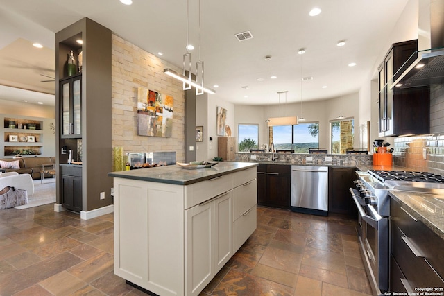 kitchen with visible vents, white cabinets, glass insert cabinets, hanging light fixtures, and stainless steel appliances