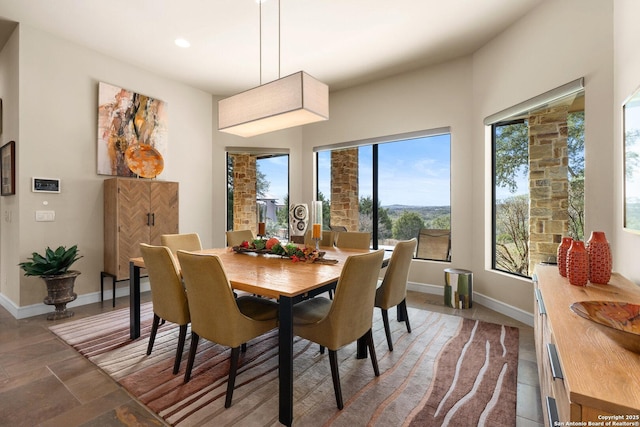 dining room featuring recessed lighting and baseboards