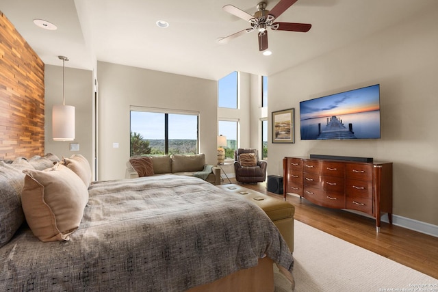 bedroom featuring recessed lighting, a towering ceiling, dark wood-type flooring, ceiling fan, and baseboards