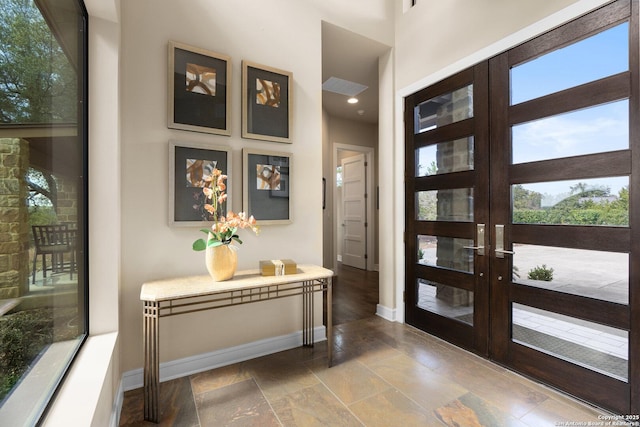 foyer with baseboards and french doors