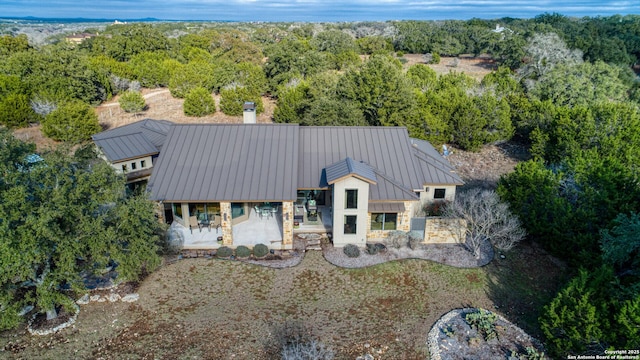 birds eye view of property featuring a wooded view