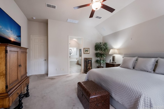 bedroom featuring lofted ceiling, visible vents, connected bathroom, and light carpet