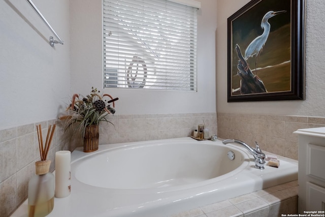 full bathroom featuring a bath and vanity