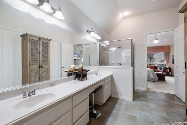 ensuite bathroom with ensuite bathroom, a closet, a sink, and lofted ceiling