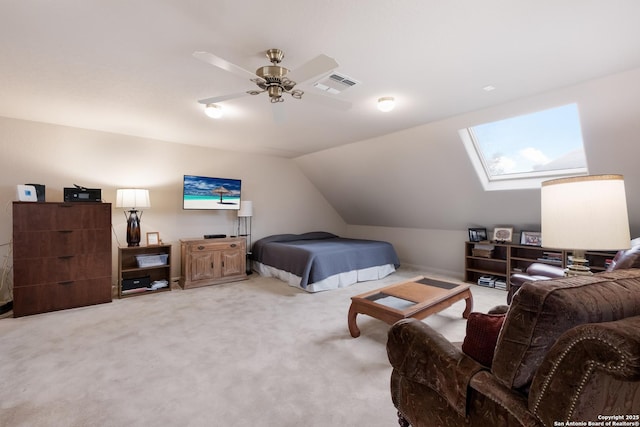 bedroom with vaulted ceiling with skylight, visible vents, and light carpet