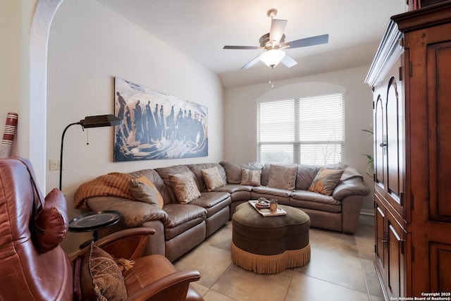 living area with a ceiling fan and light tile patterned floors