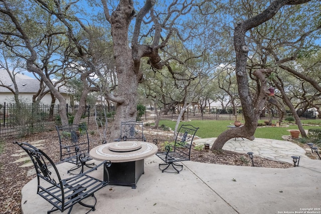 view of patio / terrace with fence and a fire pit