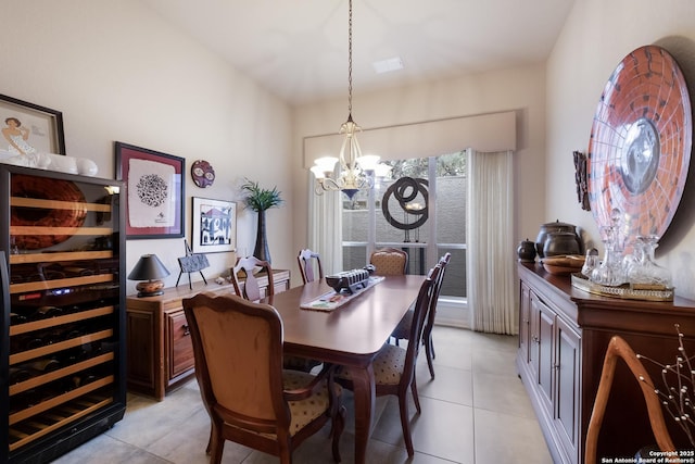 dining area featuring wine cooler, light tile patterned flooring, and an inviting chandelier