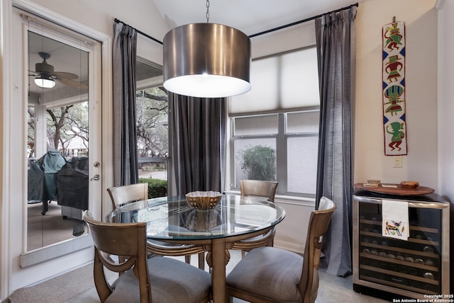 dining space with lofted ceiling, beverage cooler, and a ceiling fan