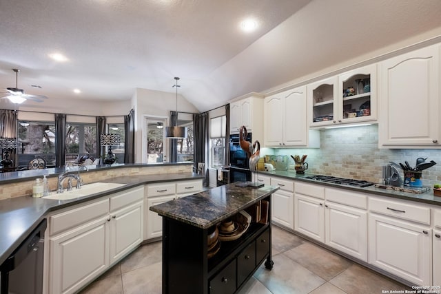 kitchen featuring glass insert cabinets, white cabinets, stainless steel gas stovetop, and dishwasher