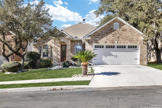 view of front of house with a shingled roof, brick siding, driveway, and an attached garage