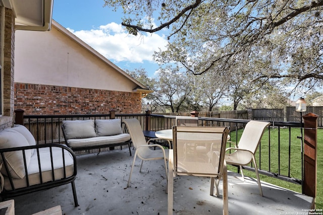 view of patio / terrace with outdoor dining space, a fenced backyard, and an outdoor living space