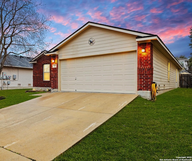 single story home featuring an attached garage, driveway, a front yard, and brick siding