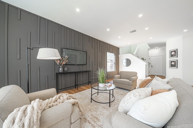 living room featuring light wood-style floors, recessed lighting, and visible vents