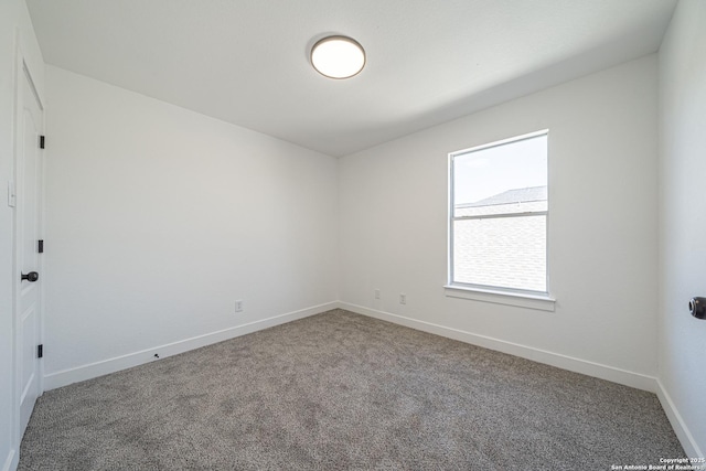 carpeted spare room with baseboards