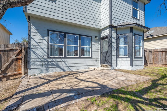 rear view of property with a patio area and fence