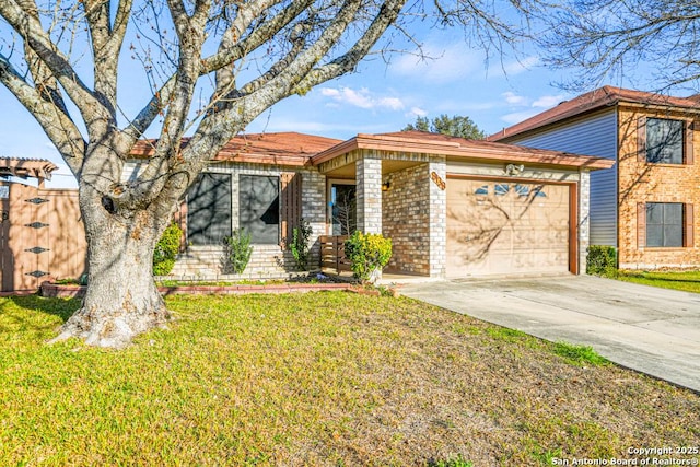 view of front of home with driveway, brick siding, an attached garage, fence, and a front yard