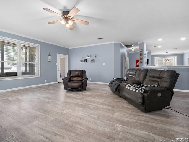 living area with visible vents, crown molding, light wood-style flooring, and baseboards