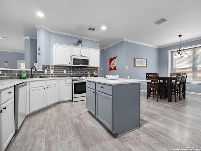 kitchen featuring stainless steel appliances, visible vents, white cabinetry, light countertops, and gray cabinets