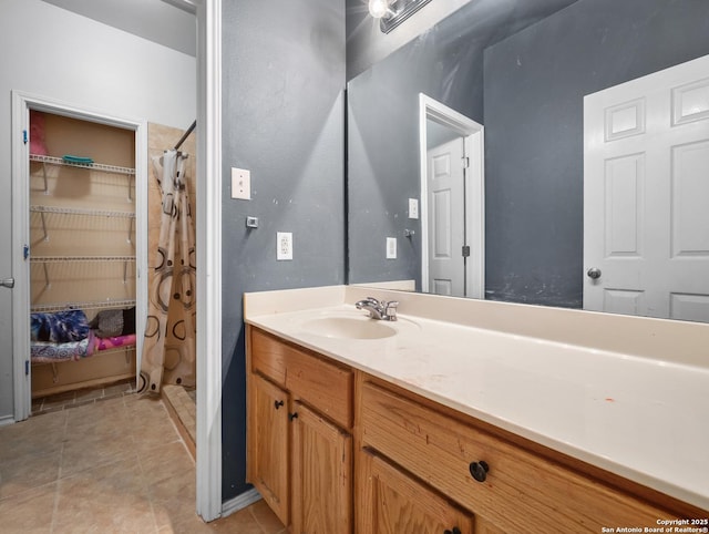 full bath featuring a shower stall, vanity, and tile patterned floors