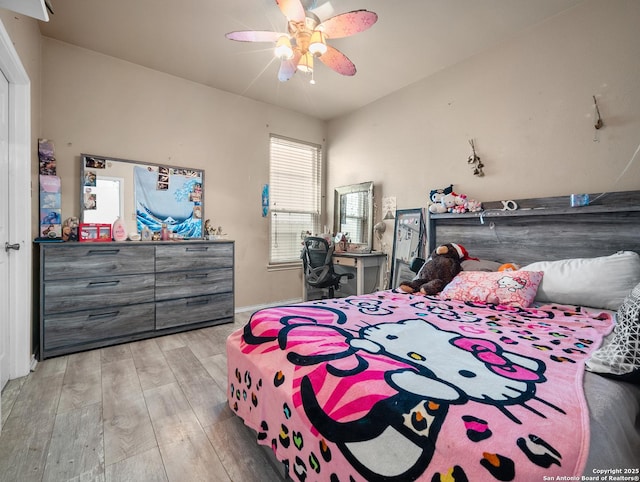 bedroom featuring light wood-style floors and a ceiling fan