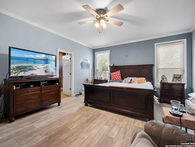 bedroom featuring baseboards, crown molding, light wood finished floors, and ceiling fan