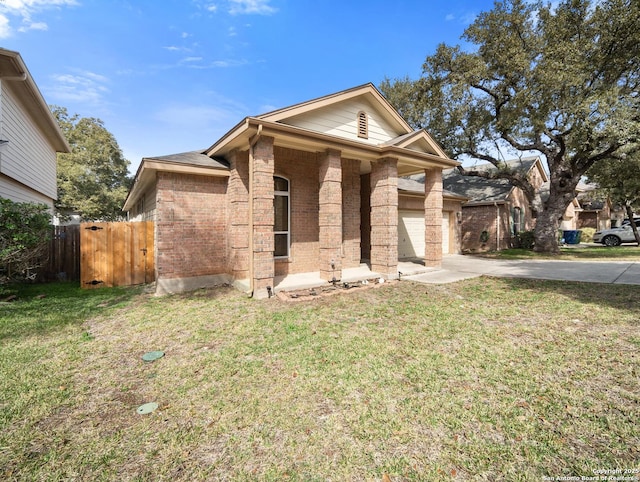 view of front of property with driveway, brick siding, a front yard, and fence