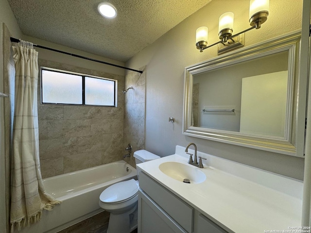 full bath with a textured wall, toilet, shower / tub combo, a textured ceiling, and vanity