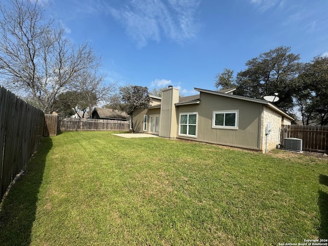 view of yard with a fenced backyard, cooling unit, and a patio