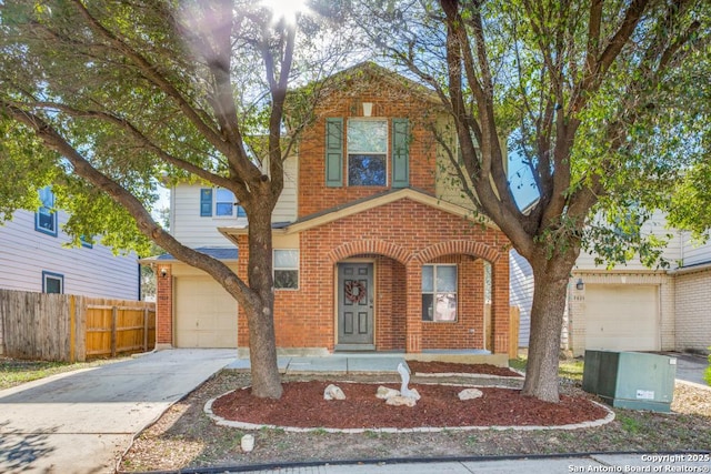 traditional home featuring a garage, concrete driveway, brick siding, and fence