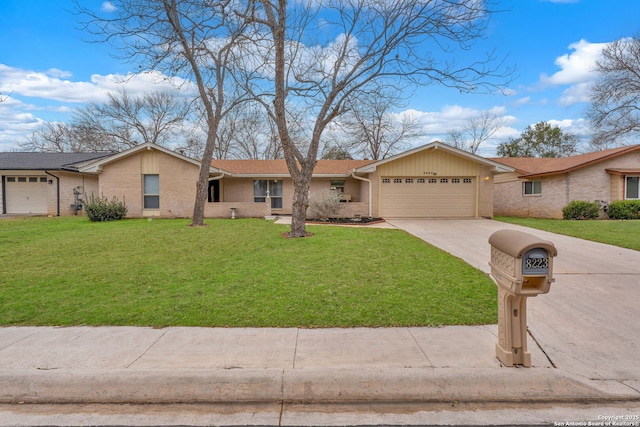 view of front of home featuring an attached garage, a front lawn, concrete driveway, and brick siding