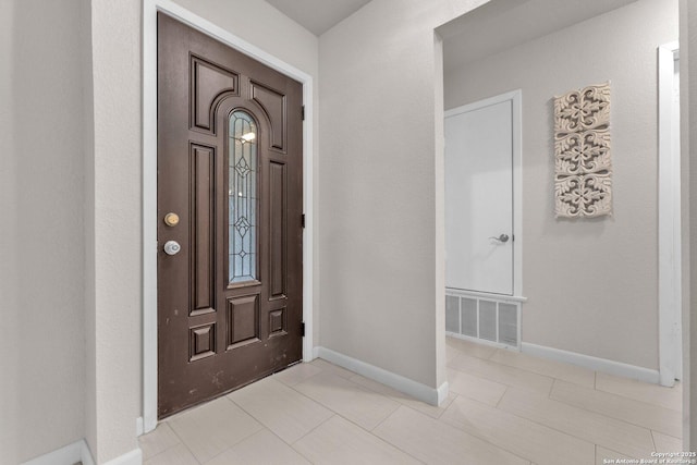 entrance foyer featuring light tile patterned flooring, visible vents, and baseboards